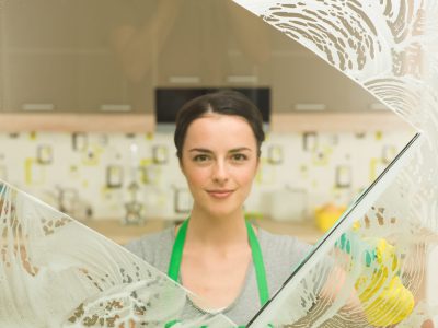 housewife spring cleaning young beautiful housewife washing window at home